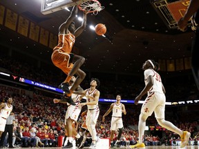 Texas forward Mohamed Bamba (4) dunks the ball over Iowa State forward Solomon Young, right, during the first half of an NCAA college basketball game, Monday, Jan. 1, 2018, in Ames, Iowa.