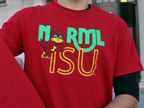 FILE - In this Nov. 15, 2012, file photo, shows a T-shirt from the Iowa State University chapter of the National Organization for the Reform of Marijuana Legislation showing the organization's logo on the front with an ISU mascot Cy the Cardinal being worn in Ames, Iowa. The university's crackdown on the pro-marijuana student group's t-shirts is expected to cost taxpayers hundreds of thousands of dollars in damages and legal fees. Subject to the approval by a state board Tuesday, Jan. 9, 2018, the state has agreed to pay $150,000 in damages to Erin Furleigh and Paul Gerlich, two leaders of the university chapter of the National Organization for the Reform of Marijuana Laws.