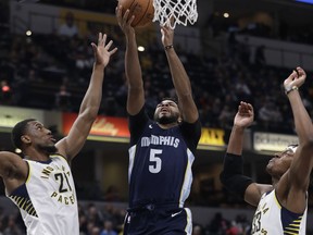 Memphis Grizzlies' Andrew Harrison (5) shoots against Indiana Pacers' Thaddeus Young, left, and Myles Turner during the first half of an NBA basketball game Wednesday, Jan. 31, 2018, in Indianapolis.