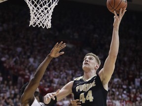 Purdue's Isaac Haas (44) shoots over Indiana's Freddie McSwain Jr. during the first half of an NCAA college basketball game, Sunday, Jan. 28, 2018, in Bloomington, Ind.