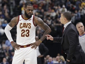 Cleveland Cavaliers head coach Tyronn Lue, front right, talks with LeBron James during the second half of an NBA basketball game against the Indiana Pacers, Friday, Jan. 12, 2018, in Indianapolis.