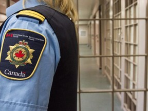 A correctional officer looks on at the Collins Bay Institution in Kingston, Ont., on Tuesday, May 10, 2016, during a tour of the facility. Federal prisoners have lost a court bid to overturn pay cuts brought in by the former Conservative government.THE CANADIAN PRESS/Lars Hagberg