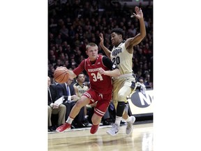 Wisconsin guard Brad Davison (34) drives on Purdue guard Nojel Eastern (20) in the first half of an NCAA college basketball game in West Lafayette, Ind., Tuesday, Jan. 16, 2018.