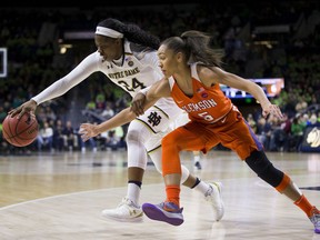 Notre Dame's Arike Ogunbowale (24) grabs a loose ball next to Clemson's Danielle Edwards (5) during the first half of an NCAA college basketball game Sunday, Jan. 21, 2018, in South Bend, Ind.