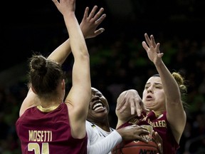 Notre Dame's Arike Ogunbowale (24) gets double-teamed by Boston College's Martina Mosetti (21) and Andie Anastos during the first half of an NCAA college basketball game Sunday, Jan. 14, 2018, in South Bend, Ind.