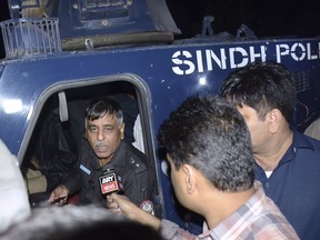 In this Tuesday night, Jan. 16, 2018, photo, Pakistani police officer Rao Anwar, who reportedly escaped an attack, talks to reporters in Karachi, Pakistan. Pakistani police says senior officer Anwar known for leading raids on militant hideouts, escaped assassination when a suicide bomber riding on a motorcycle blew himself up near his vehicle in the port city of Karachi.