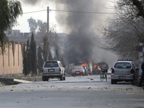 Vehicles burn after a deadly suicide attack in Jalalabad, east of Kabul, Afghanistan, Wednesday, Jan. 24, 2018. Attahullah Khogyani, spokesman for the provincial governor said a group of gunmen stormed the office of the non-governmental organization, Save the Children.