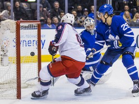 Artemi Panarin of the Columbus Blue Jackets redirects the puck into the net past Toronto Maple Leafs' goaltender Frederik Andersen for the game-winning goal in overtime in NHL action Monday night at the ACC. Leafs' William Nylander tries to impede Panarin from close in. The Blue Jackets overcame a 2-0 deficit to prevail 3-2.