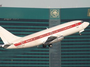 A Janet 737-200 departing from McCarran International Airport, Las Vegas, Nevada with the MGM Grand Las Vegas in the background.