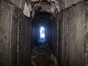 People can be seen standing on the Israeli side of the border with Gaza, from an opening in a tunnel, that Israel says was dug by the Islamic Jihad militant group, leading from Gaza into Israel, near the southern Israeli kibbutz of Kissufim, Israel, Thursday, Jan. 18, 2018. The Israeli army showed journalists the tunnel that was uncovered and partially destroyed in late October, 2017.