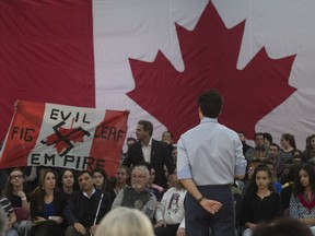 A heckler screams at Prime Minister Justin Trudeau during a town hall meeting Thursday, January 18, 2018 in Quebec City.