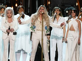 Kesha (C) performs with Cyndi Lauper (L) and Camila Cabello (R) onstage during the 60th Annual GRAMMY Awards at Madison Square Garden on January 28, 2018 in New York City.