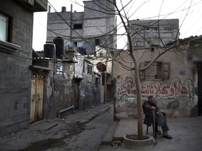 In this Thursday Jan. 11, 2018 photo, a Palestinian sits outside his house in the Shati refugee camp in Gaza City. From the Gaza Strip to Jordan and Lebanon, millions of Palestinians are bracing for the worst as the Trump administration moves toward cutting funding to the U.N. agency that assists Palestinian refugees across the region. The expected cuts could deliver a painful blow to some of the weakest populations in the Middle East and risk destabilizing the already struggling countries that host displaced Palestinian refugees and their descendants.