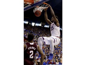 Kansas' Udoka Azubuike gets past Texas A&M's TJ Starks to dunk the ball during the first half of an NCAA college basketball game Saturday, Jan. 27, 2018, in Lawrence, Kan.