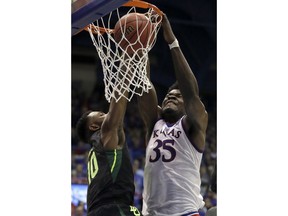 Kansas center Udoka Azubuike (35) dunks against Baylor guard Tyson Jolly (10) during the first half of an NCAA college basketball game in Lawrence, Kan., Saturday, Jan. 20, 2018.