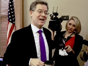 Kansas Gov. Sam Brownback reacts Wednesday, Jan. 24, 2018, to the news that his nomination to become ambassador-at-large for international religious freedom advanced Wednesday on a tied procedural vote broken by Vice President Mike Pence. Brownback had just finished presiding over the State Finance Council, which voted to approve a $362 million rebuild of Lansing Correctional Facility.