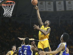 Wichita State forward Rashard Kelly takes a shot over Tulsa guard Sterling Taplin during the first half of an NCAA college basketball game on Sunday, Jan. 28, 2018 in Wichita, Kan.