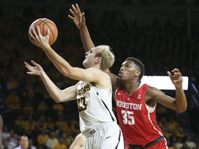 Wichita State guard Conner Frankamp goes to the basket against Houston forward Fabian White Jr. during the first half of an NCAA college basketball game in Wichita, Kan., Thursday, Jan. 4, 2018.