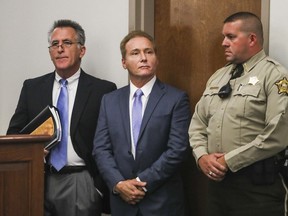 FILE - In this Thursday, Nov. 9, 2017 file photo, Rene Boucher, center, appears in court for an arraignment hearing with his attorney Matt Baker, left, at the Warren County Justice Center in Bowling Green, Ky. Boucher the man accused of tackling U.S. Sen. Rand Paul in the Kentucky lawmaker's yard has been charged with assaulting a member of Congress as part of a federal plea agreement.