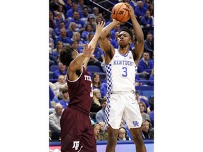 Kentucky's Hamidou Diallo, right, shoots while defended by Texas A&M's Admon Gilder during the first half of an NCAA college basketball game, Tuesday, Jan. 9, 2018, in Lexington, Ky.