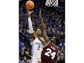 Kentucky's Jarred Vanderbilt (2) shoots while defended by Mississippi State's Abdul Ado (24) during the first half of an NCAA college basketball game, Tuesday, Jan. 23, 2018, in Lexington, Ky.