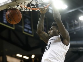 Cincinnati's Nysier Brooks dunks during the first half of the team's NCAA college basketball game against Houston, Wednesday, Jan. 31, 2018, in Highland Heights, Ky.