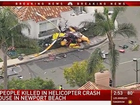 This still frame from video provided by KNBC-TV shows the wreckage of a Robinson R44 helicopter after it crashed into a home in Newport Beach, Calif., Tuesday, Jan. 30, 2018.