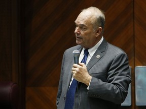 FILE - In this Tuesday, Jan. 9, 2018 file photo, Arizona state Rep. Don Shooter, R-Yuma, reads a statement regarding sexual harassment and other misconduct complaints made against him by Rep. Michelle Ugenti-Rita and others, on the House floor at the Capitol in Phoenix. An internal investigation released Tuesday, Jan. 30, 2018, found that Shooter violated the chamber's sexual harassment policies and has been permanently removed from all committee assignments.