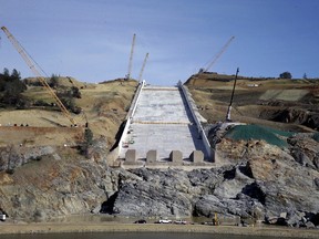 FILE - In this Nov. 30, 2017, file photo, work continues on the Oroville Dam spillway in Oroville, Calif. The city of Oroville plans to sue state water officials for damages caused when thousands of its residents had to be evacuated last year after the Oroville Dam spillways failed. Oroville City Attorney Scott Huber says the city will file the lawsuit Wednesday, Jan. 17, 2018.