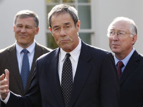 FILE - In this Nov. 2, 2009 file photo, former Alaska Gov. Tony Knowles, center, accompanied by Rep. Jay Inslee, D-Wash., left, and Interior Secretary Ken Salazar, gestures while speaking to members of the media following their meeting at the White House in Washington. A U.S. Interior Department official has reacted harshly to the resignation of most members of a board that advises it on national parks. Knowles chaired the congressionally authorized board until Tuesday, Jan. 16, 2018, the Democrat and eight others on the 12-member board sent a resignation letter, saying their requests to meet as prescribed in law have been disregarded.
