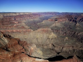 FILE - In this Oct. 5, 2013, file photo, the Grand Canyon National Park is covered in the morning sunlight as seen from a helicopter near Tusayan, Ariz. Arizona officials on Friday, Jan. 19, 2018, guaranteed that the Grand Canyon National Park will remain in full operation if Congress fails to pass a budget and a government shutdown ensues.