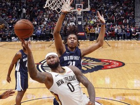 New Orleans Pelicans center DeMarcus Cousins (0) goes to the basket in front of Memphis Grizzlies center Deyonta Davis (21) in the first half of an NBA basketball game in New Orleans, Saturday, Jan. 20, 2018.