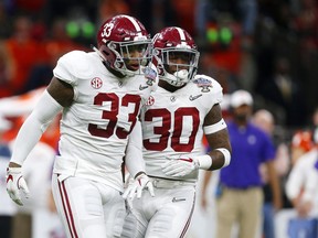 Alabama linebacker Anfernee Jennings (33) and linebacker Mack Wilson (30) celebrate a stop in the first half of the Sugar Bowl semi-final playoff game against Clemson for the NCAA college football national championship, in New Orleans, Monday, Jan. 1, 2018.