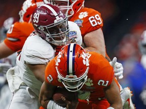 Alabama defensive lineman Raekwon Davis (99) sacks Clemson quarterback Kelly Bryant (2) in the first half of the Sugar Bowl semi-final playoff game for the NCAA college football national championship, in New Orleans, Monday, Jan. 1, 2018.