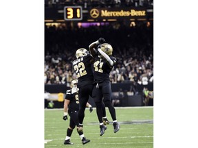 New Orleans Saints running back Alvin Kamara (41) celebrates his touchdown carry with running back Mark Ingram (22) in the second half of an NFL football game against the Carolina Panthers in New Orleans, Sunday, Jan. 7, 2018.