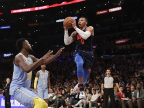 Oklahoma City Thunder's Russell Westbrook goes up for a shot in front of Los Angeles Lakers' Julius Randle during the first half of an NBA basketball game Wednesday, Jan. 3, 2018, in Los Angeles.