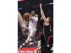 Oklahoma City Thunder guard Russell Westbrook, left, goes up for a shot as Los Angeles Clippers forward Blake Griffin defends during the first half of an NBA basketball game, Thursday, Jan. 4, 2018, in Los Angeles.