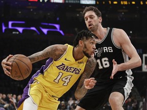 Los Angeles Lakers' Brandon Ingram, left, drives past San Antonio Spurs' Pau Gasol, of Spain, during the first half of an NBA basketball game Thursday, Jan. 11, 2018, in Los Angeles.