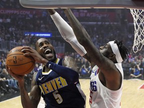 Denver Nuggets guard Will Barton, left, shoots as Los Angeles Clippers center Willie Reed defends during the first half of an NBA basketball game, Wednesday, Jan. 17, 2018, in Los Angeles.