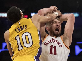 Indiana Pacers center Domantas Sabonis, right, is fouled by Los Angeles Lakers guard Tyler Ennis during the first half of an NBA basketball game Friday, Jan. 19, 2018, in Los Angeles.