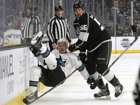 San Jose Sharks rignt winger Joonas Donskoi (27) and Los Angeles Kings defenseman Kurtis MacDermid (56) tangle in the first period of an NHL hockey game in Los Angeles, Monday, Jan. 15, 2018.