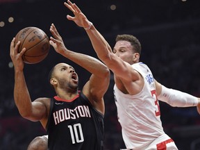 Houston Rockets guard Eric Gordon, left, shoots as Los Angeles Clippers forward Blake Griffin defends during the first half of an NBA basketball game, Monday, Jan. 15, 2018, in Los Angeles.