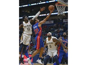 Detroit Pistons guard Avery Bradley (22) drives to the basket against New Orleans Pelicans guard Jrue Holiday (11) in the first half of an NBA basketball game in New Orleans, Monday, Jan. 8, 2018.