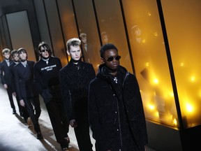 Models wear creations for the Dior men's Fall-Winter 2018/2019 fashion collection presented in Paris, Saturday, Jan.20, 2018.