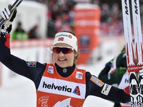 Ingvild Flugstad Oestberg of Norway celebrates after winning the women's ten kilometers pursuit cross country race at the Tour de Ski in Lenzerheide, Switzerland, Monday, Jan. 1, 2018.