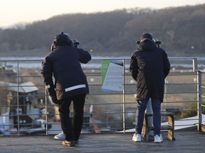 Visitors use binoculars to see the North side from the Imjingak Pavilion in Paju, South Korea, Wednesday, Jan. 3, 2018. North Korean leader Kim Jong Un reopened a key cross-border communication channel with South Korea for the first time in nearly two years Wednesday as the rivals explored the possibility of sitting down and talking after months of acrimony and fears of war.