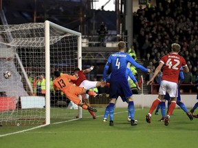 Nottingham Forest's Eric Lichaj scores his side's first goal of the game during the English FA Cup, Third Round soccer match between Nottingham Forest and Arsenal at the City Ground, Nottingham, England, Sunday, Jan. 7, 2018.