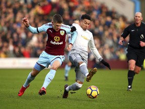 Burnley's Johann Berg Gudmundsson, left, and Manchester United's Jesse Lingard battle for the ball during their English Premier League soccer match at Turf Moor, Burnley, England, Saturday, Jan. 20, 2018.