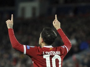 FILE - In this file photo dated Wednesday, Dec. 6, 2017, Liverpool's Philippe Coutinho celebrates after scoring during the Champions League soccer match between Liverpool and Spartak Moscow at Anfield in Liverpool, England.  Coutinho arrives at Barcelona soccer club Sunday Jan. 7, 2018, signed from Liverpool for a huge price tag and expected to continue the long line of Brazilian stars who have dazzled at Camp Nou.