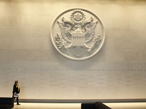 FILE - In this Wednesday, Dec. 13, 2017 file photo, a general view of the main lobby entrance with a large Department of State embossed seal, along with all the names of the ambassadors to the Court of St James's at the new United States embassy building during a press preview near the River Thames in London. President Donald Trump says he is canceling an upcoming trip to London because he doesn't like the Obama administration's choice of a new embassy there.